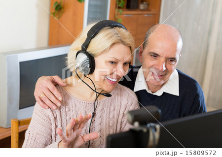 Pensioner sitting together at the computer Pensioner sitting together at the computer 15809572