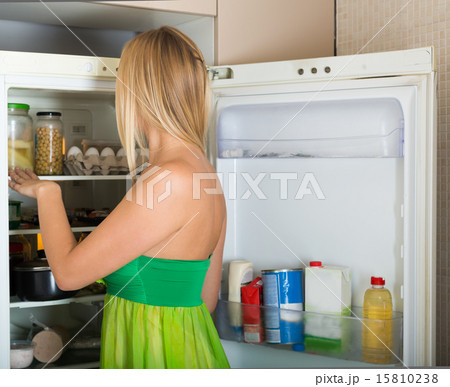 woman looking for something in refrigerator woman looking for something in refrigerator 15810238