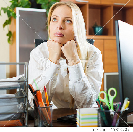 woman in white dreaming at office desk 15810287