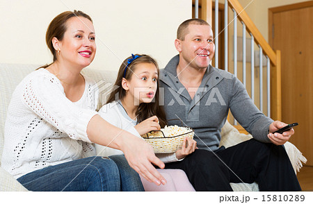Family sitting with popcorn Family sitting with popcorn 15810289