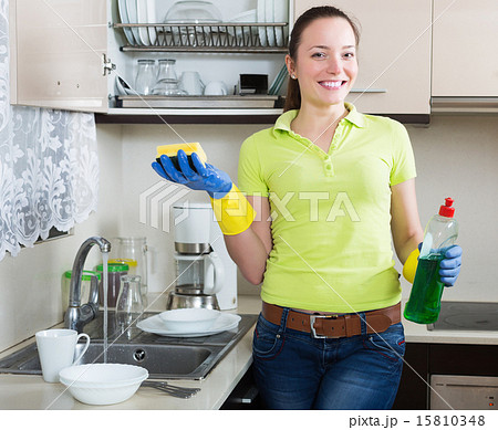 Positive young housewife washing dishes 15810348