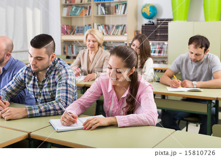 Adult students writing in classroom 15810726