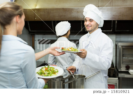 Waitress with plates at kitchen Waitress with plates at kitchen 15810921