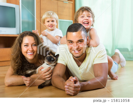 Parents and two daughters with Siamese Parents and two daughters with Siamese 15811058