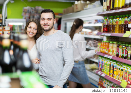 Customers at beverages section of supermarket 15811143
