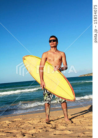 Surfer with a surfboard on beach Surfer with a surfboard on beach 15854075