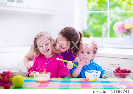 Mother and children having breakfast 15860741