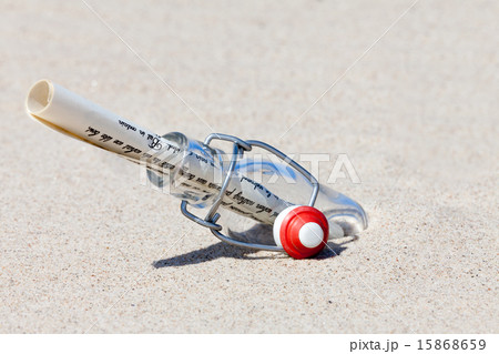 A message in a bottle is in the sand on the beach A message in a bottle is in the sand on the beach 15868659