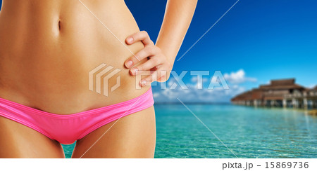 Woman on beautiful beach with water bungalows Woman on beautiful beach with water bungalows 15869736
