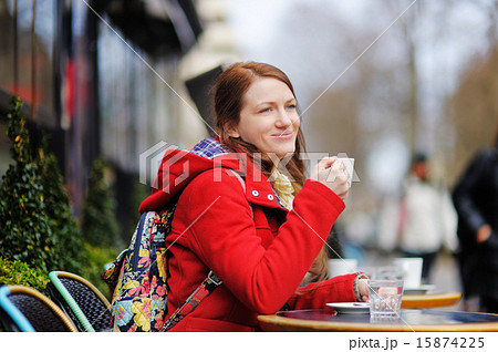 Young woman drinking coffee in a street cafe Young woman drinking coffee in a street cafe 15874225
