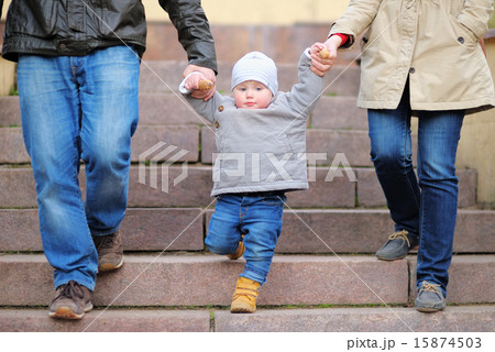 Toddler boy walking with his parents Toddler boy walking with his parents 15874503
