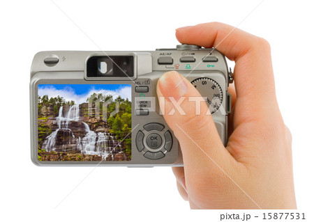 Hand with camera and Norway travel photo 15877531