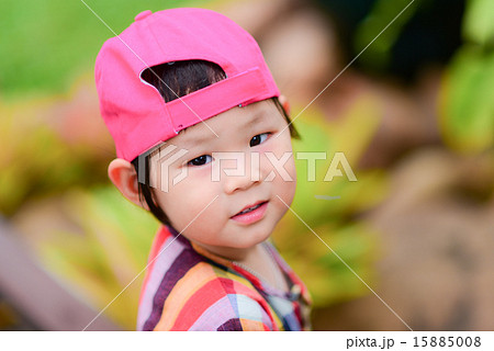 Cute Asian girl wearing pink cap. 15885008