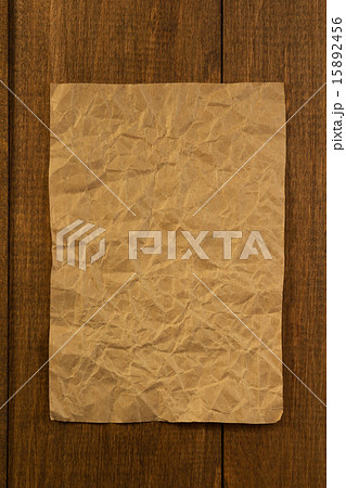 wrinkled note paper on wood 15892456