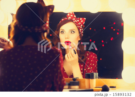 woman applying cosmetics 15893132