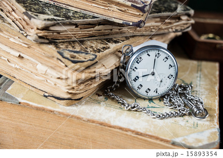 Old books and  pocketwatch 15893354