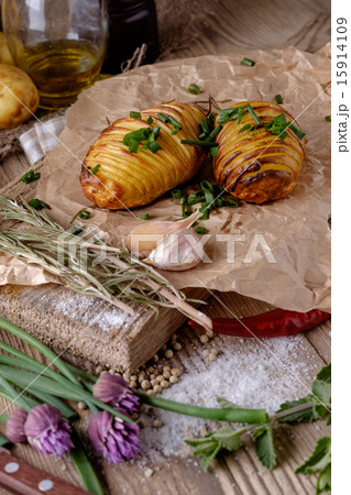 Sliced baked potatoes over wooden background. 15914109