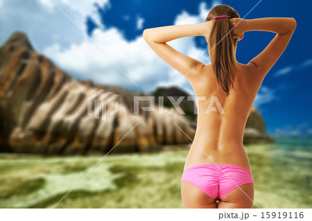 Woman topless on beautiful beach at Seychelles 15919116