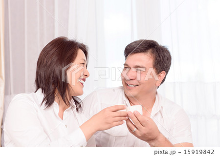 Smiling Asian family drinking tea 15919842