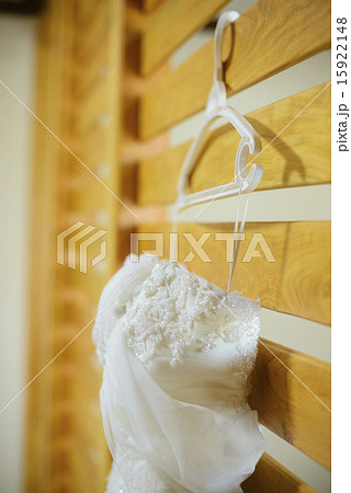 Wedding dress hanging against a wall 15922148