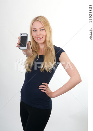 Blond smiling girl showing mobile phone 15923383