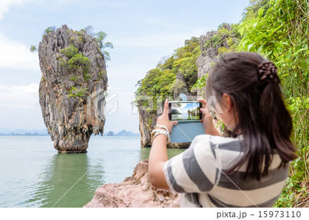 Female traveler shooting natural view by mobile phone Female traveler shooting natural view by mobile phone 15973110