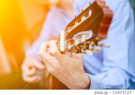 Young musician playing at acoustic guitar Young musician playing at acoustic guitar 15973727