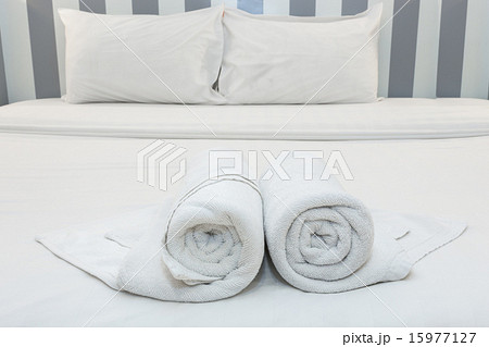 nice towels on white bed sheet with white pillow nice towels on white bed sheet with white pillow 15977127