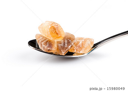 brown caramelized sugar in a wooden spoon brown caramelized sugar in a wooden spoon 15980049