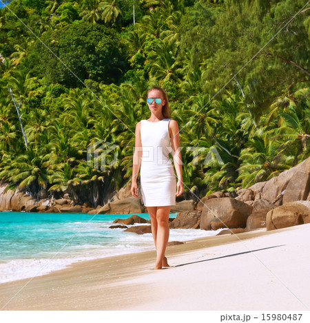 Woman wearing dress on beach at Seychelles 15980487