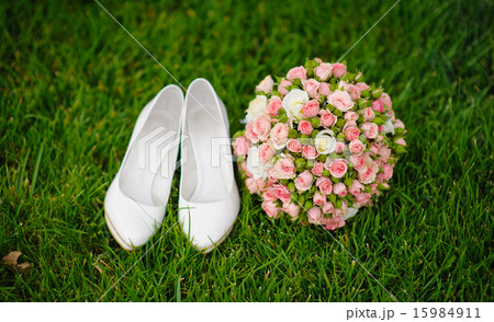 wedding bouquet and shoes lying 15984911
