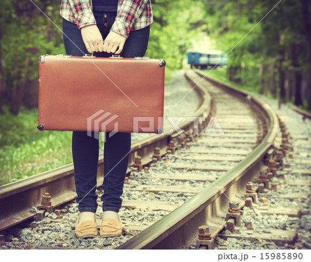 young woman with old suitcase on railway young woman with old suitcase on railway 15985890
