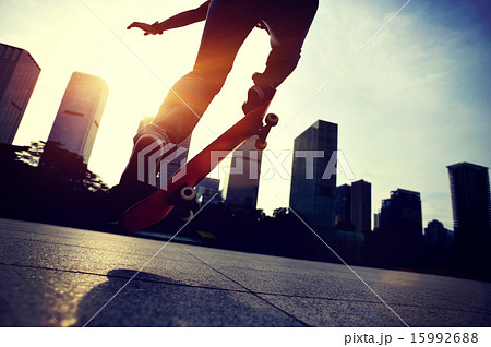skateboarder doing skateboarding trick ollie on sunrise city 15992688