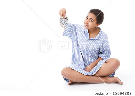 Pretty young mulatto girl holding alarm clock  15994803
