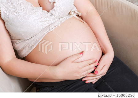 Pregnant woman sitting in  the armchair 16003256