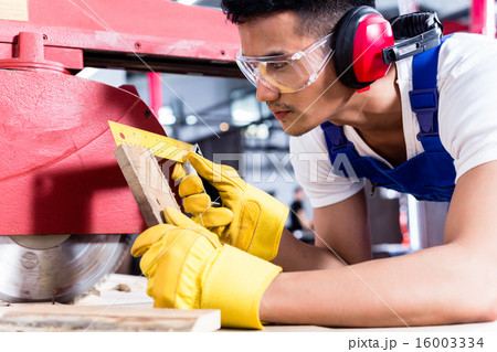 Carpenter in Asian workshop with circular saw Carpenter in Asian workshop with circular saw 16003334