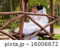 Couple love bride and groom posing sitting on wood 16006672