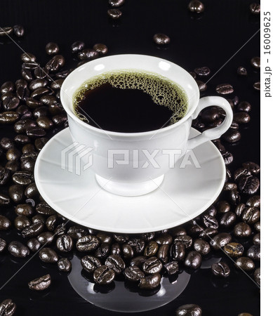 Coffee cup with roasted beans on black Coffee cup with roasted beans on black 16009625