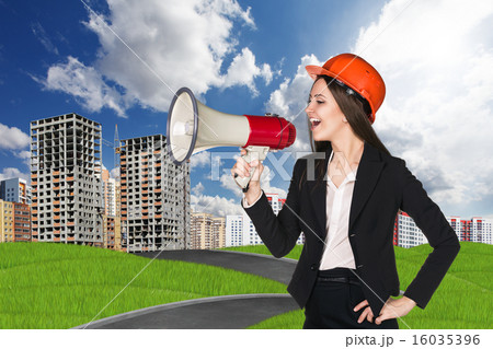 Woman in hardhat with megaphone  16035396