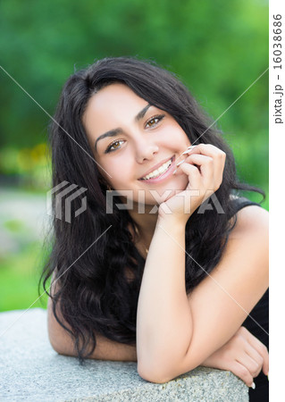 Portrait of young cheerful brunette 16038686