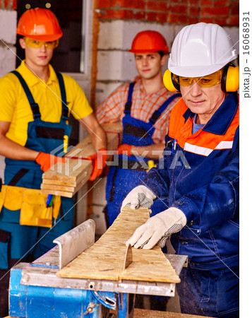 Group people  builder with circular saw . 16068931