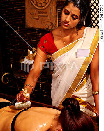 Woman having massage with pouch of rice. Woman having massage with pouch of rice. 16069729