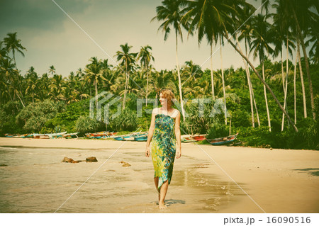 Woman walking on tropical beach - retro style Woman walking on tropical beach - retro style 16090516