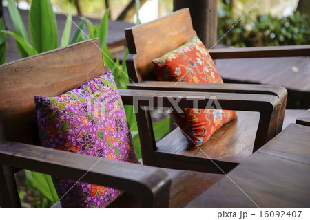 Pillow cushions on brown wood chair Pillow cushions on brown wood chair 16092407
