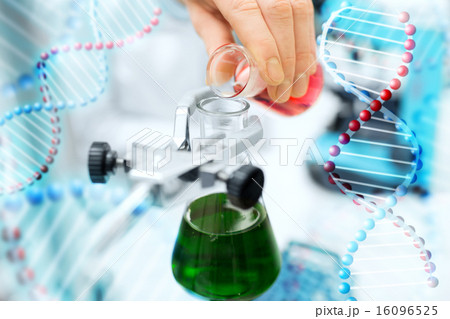 close up of scientist filling test tubes in lab 16096525