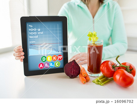 close up of woman with tablet pc and vegetables close up of woman with tablet pc and vegetables 16096702