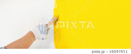 close up of male in gloves painting a wall 16097651