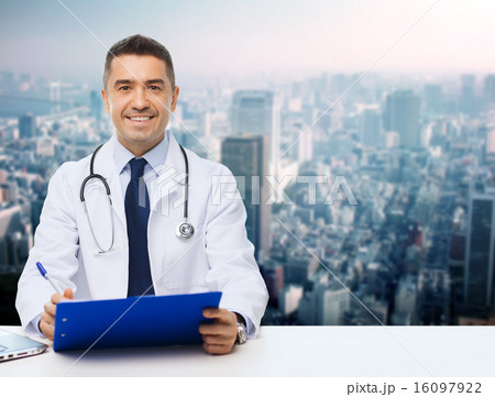 happy doctor with clipboard over city background happy doctor with clipboard over city background 16097922