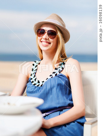 girl in shades in cafe on the beach girl in shades in cafe on the beach 16098139