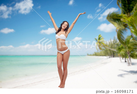happy woman in bikini swimsuit dancing on beach 16098171
